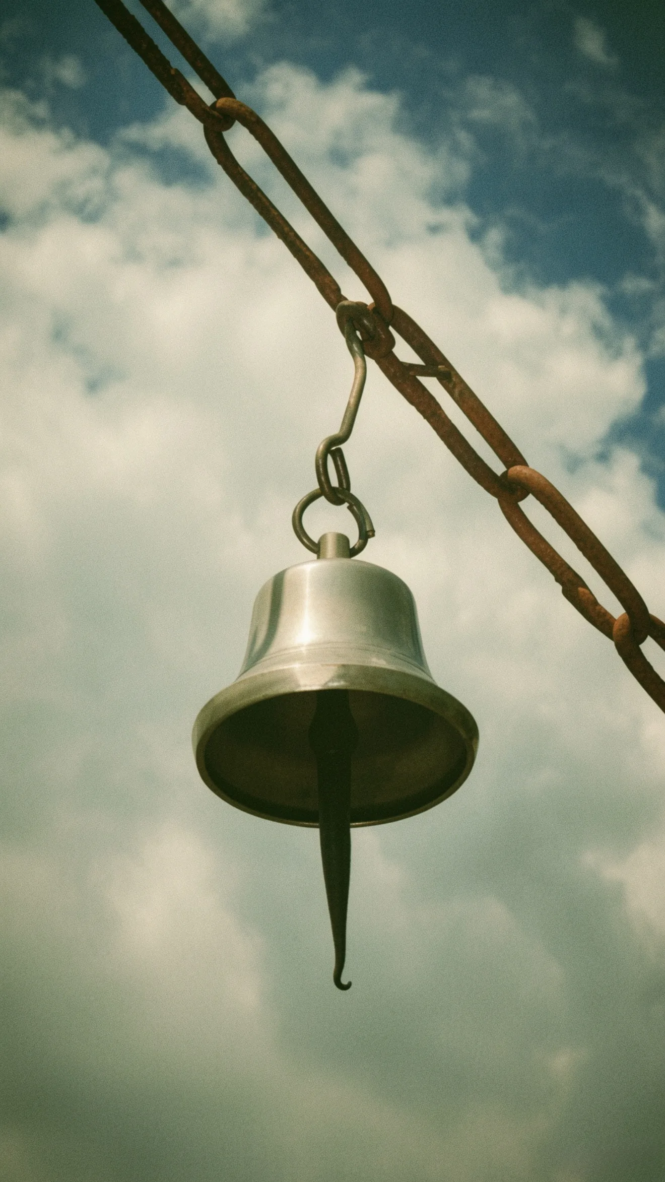 bhutanese-bronze-bell-cloudy-sky